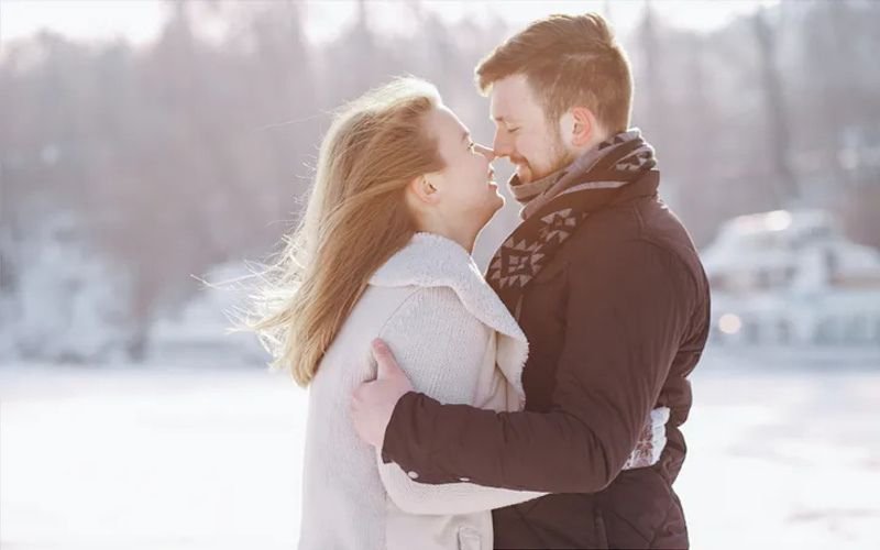 Happy couple embracing outdoors in winter, representing love and connections made through the best dating websites for casual hookups.