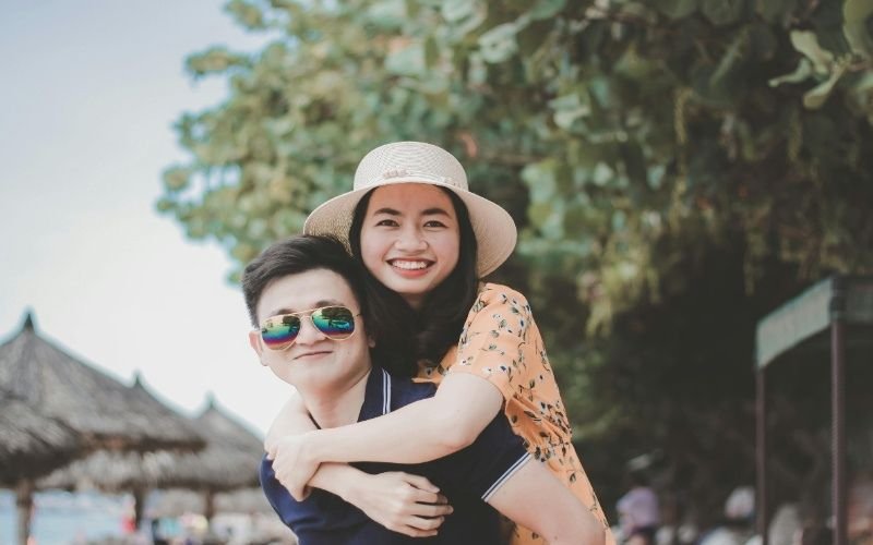 Smiling couple enjoying a fun moment outdoors, showcasing happiness and excitement found through the best dating websites for casual hookups.