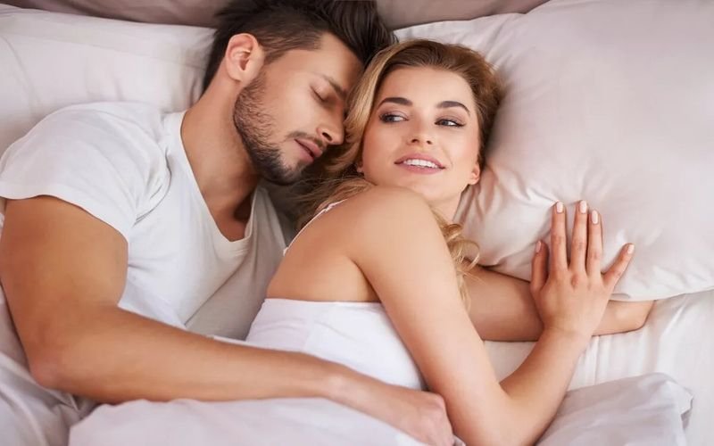 Couple relaxing together in bed, reflecting intimacy and connections formed through the best dating websites for casual hookups.